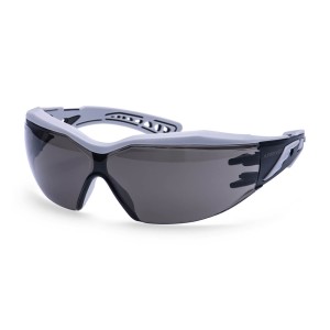 A pair of safety spectacles with clear impact-resistant lenses and adjustable side arms, for eye protection during site work.