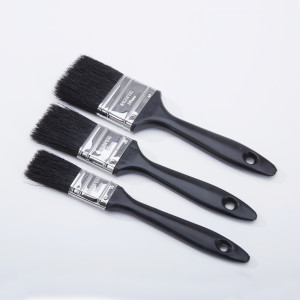 Three black-handled paintbrushes of varying sizes are arranged parallel on a white background, with their bristles facing left. Each brush has a hole at the end of the handle for hanging.