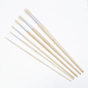 A brush with natural or synthetic bristles and an ergonomic handle, for applying coatings or cleaning surfaces.