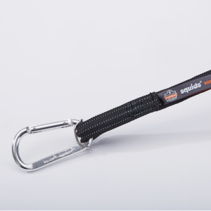 A close-up of a black strap with a silver carabiner attached, featuring the squids brand label and an Ergodyne logo on a white background.