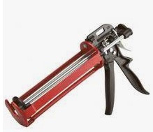 A red and black caulking gun with a metal trigger and handle, used for applying sealants from a tube.