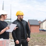 A black padded bodywarmer designed for use on construction sites and in industrial work environments.,
