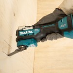 A teal and black Makita cordless power tool, 18V, with an ergonomic grip, designed for use on construction and maintenance tasks.