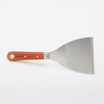 A 100mm flexible filling knife with a thin steel blade and a painted wooden or plastic handle, for applying and smoothing filler and caulk.
