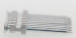 A close-up of a row of silver nails connected by a gray plastic strip, arranged in parallel on a white background.
