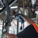 A teal and black Makita corded power tool, 110V, with an ergonomic grip, designed for use on construction and maintenance tasks.