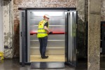 A steel metal shelving unit with adjustable shelf heights and a robust welded steel frame, for organised storage in workshops and site cabins.