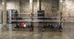A steel metal shelving unit with adjustable shelf heights and a robust welded steel frame, for organised storage in workshops and site cabins.