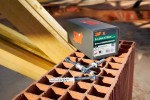A nylon frame anchor with a countersunk head and nylon expansion plug, designed for securing window and door frames to masonry walls.