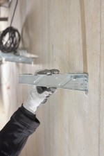 A metal through bolt anchor with a hex nut and washer, featuring a threaded shaft and expansion sleeve, designed for securing heavy loads to concrete or masonry surfaces.