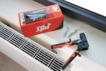 An orange and black Spit cordless power tool, with an ergonomic grip, designed for use on construction and maintenance tasks.