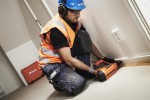 A Paslode cordless stapler with a magazine feed and safety tip, for fastening materials using heavy-duty staples.