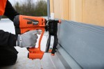 An orange and black Paslode cordless brad nailer with an angled magazine, designed for driving fine brad nails in trim and finish carpentry.