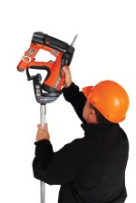 An orange and black Spit cordless power tool, with an ergonomic grip, designed for use on construction and maintenance tasks.