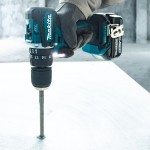 A teal and black Makita cordless impact driver with a 18V motor, a hex-chuck, and variable speed, for high-torque screw driving and fastening.