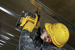 A yellow and black DEWALT cordless SDS-Plus rotary hammer drill with 18V hammer, rotation, and chisel modes, for drilling and chiselling into concrete and masonry.