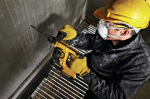 A yellow and black DEWALT cordless SDS-Plus rotary hammer drill with 18V hammer, rotation, and chisel modes, for drilling and chiselling into concrete and masonry.