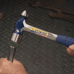 A ball pein hammer with a flat striking face and a hemispherical pein, used in metalworking for riveting and shaping.