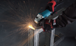 A teal and black Makita corded angle grinder with a 110V motor, a side handle, and a wheel guard, for grinding, cutting, and surface preparation.
