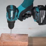 A teal and black Makita cordless combi drill with an 18V motor, a 13mm keyless chuck, and hammer, drill, and screwdriver modes.