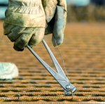 A pair of pliers with hardened steel jaws and insulated handles, for gripping and bending work.