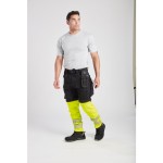 A pair of black work trousers designed for use on construction sites and in industrial work environments.,