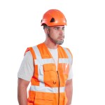 A orange safety helmet with an adjustable suspension harness and ventilation slots, providing impact protection on construction sites.