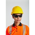 A yellow safety helmet with an adjustable suspension harness and ventilation slots, providing impact protection on construction sites.