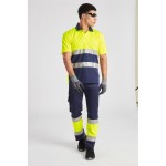 A high-visibility yellow polo shirt featuring retroreflective tape panels, suitable for a wide range of outdoor and site work applications.