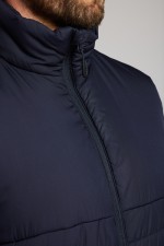 A navy blue safety vest featuring a warm thermal lining, suitable for a wide range of outdoor and site work applications.