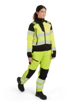 A women's high-visibility yellow jacket featuring retroreflective tape panels, suitable for a wide range of outdoor and site work applications.