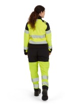 A women's high-visibility yellow jacket featuring retroreflective tape panels, suitable for a wide range of outdoor and site work applications.