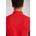 A red polo shirt designed for use on construction sites and in industrial work environments.,