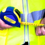 A 5m retractable tape measure with a blade, a rubberised case, and a belt clip, for general site measurement.