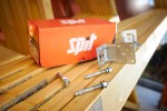 A bright zinc plated through bolt anchor with a hex nut and washer, featuring a threaded shaft and expansion sleeve, designed for securing heavy loads to concrete or masonry surfaces.