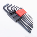 A set of black hex keys (Allen wrenches) in various sizes, held in two plastic holders—one black, one red—arranged on a white surface.