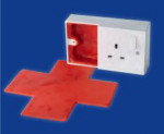 A wall electrical socket with a red cross-shaped mat extending from an open compartment, set against a blue background.