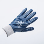 A blue protective work glove with a white cuff is shown against a plain light background. The glove has white printed text and symbols on the back.,