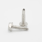 Two silver-colored self-tapping screws are shown on a white background; one screw is lying horizontally while the other stands upright, both featuring hexagonal heads and pointed, drill-like tips.