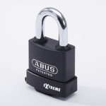 A black ABUS Extreme padlock with a silver shackle, labeled ABUS PATENTED and EXTREME on the front, standing upright against a white background.