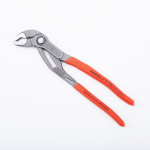 A pair of adjustable pliers with textured metal jaws and red handles, branded KNIPEX, is displayed on a white background.