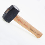 A club hammer with a double-faced steel head and a short wooden handle, used for driving bolsters, chisels, and masonry stakes.