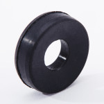 A black rubber washer with a central hole, standing upright on a white background.