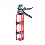 A red and black manual caulking gun with a double-barrel design, metal rods, and ergonomic handles, isolated on a white background.