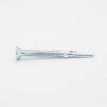 A single silver metal screw with a flat, countersunk head and a ridged body, lying horizontally on a plain white background.