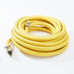 A coiled yellow hose with metal connectors on both ends, placed on a white surface.