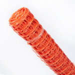 A rolled-up orange plastic mesh safety fence, commonly used for construction sites or event crowd control, is pictured against a plain white background.