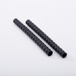 Two black, ridged, cylindrical rods are placed parallel to each other on a white surface.