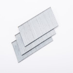 Three overlapping strips of silver metal staples arranged diagonally on a white background.,