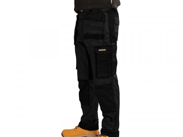 A pair of work trousers designed for use on construction sites and in industrial work environments.,